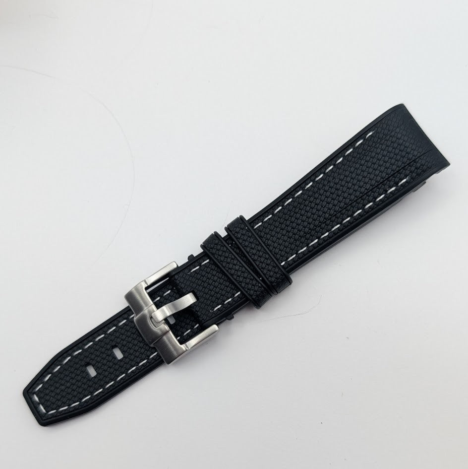 Black watch strap with silver buckle on a light gray background