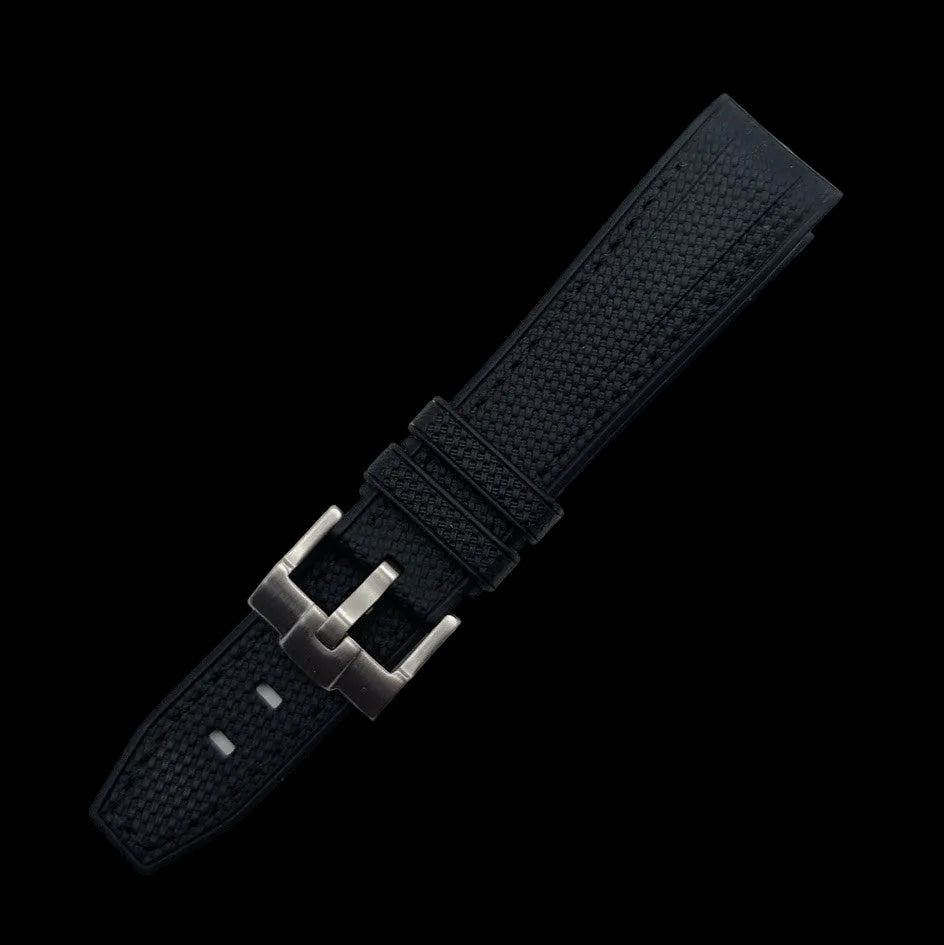 Black watch strap with silver buckle on a light gray background