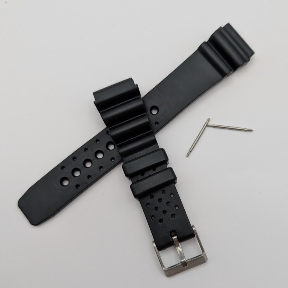 Black watch strap with metal buckle on a light gray background