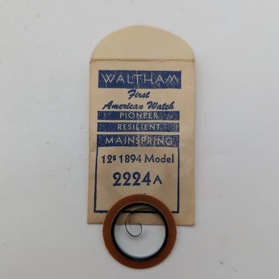 Waltham watch mainspring with packaging on a white background
