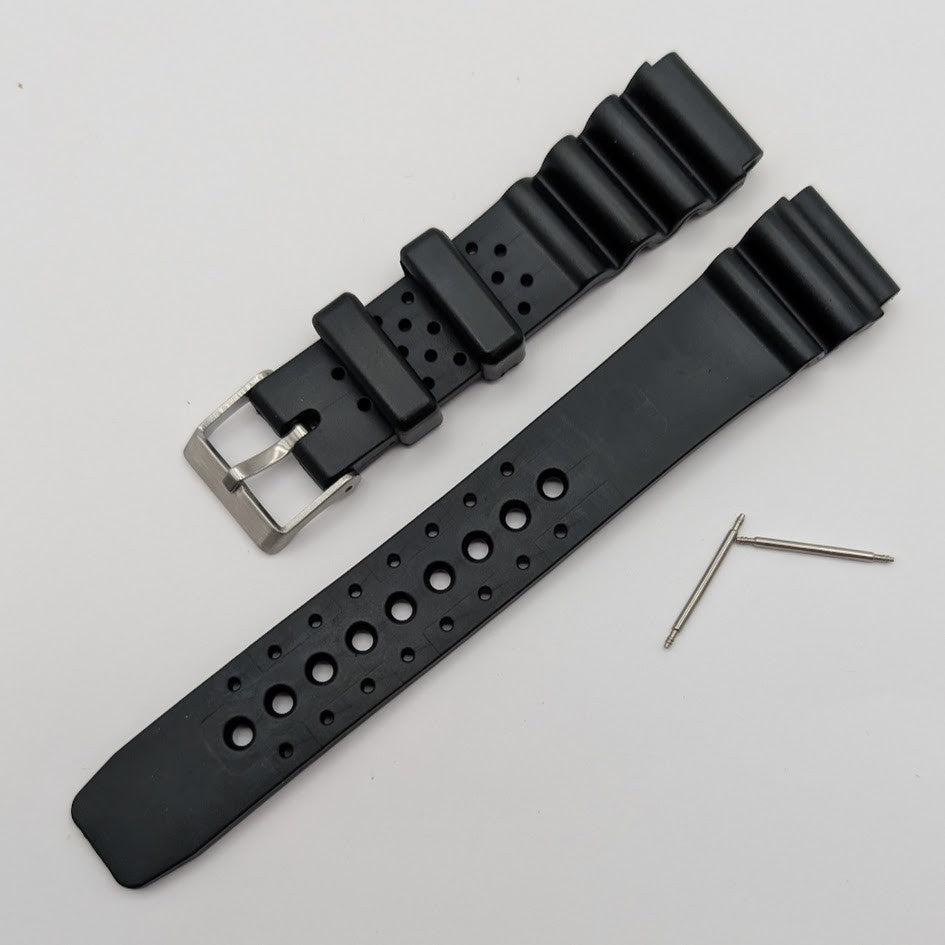 Black watch strap with silver buckle on a light gray background