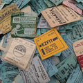 Collection of vintage watch crystal packaging labels on a textured surface.